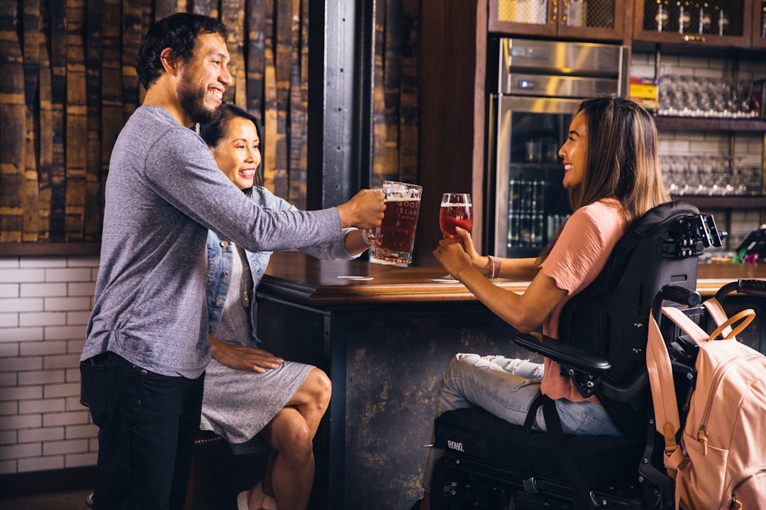 shallow focus photo of woman holding footed wine glass