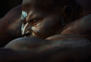 A close-up of a finely detailed bronze statue of a historical figure, highlighting the texture and craftsmanship.