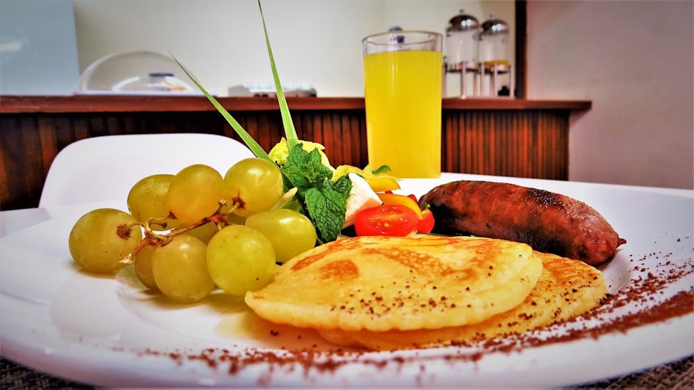 pancakes beside grapes in plate