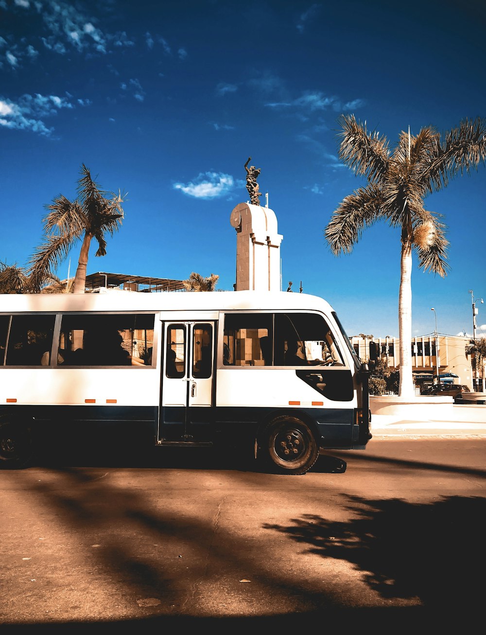 white and blue bus under blue sky