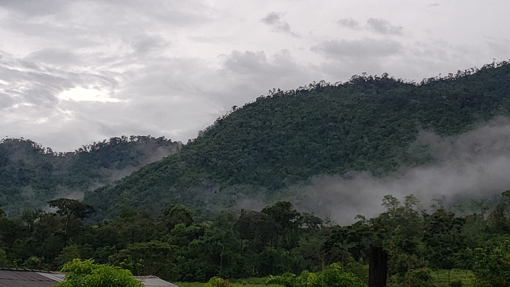 green mountain under a cloudy sky