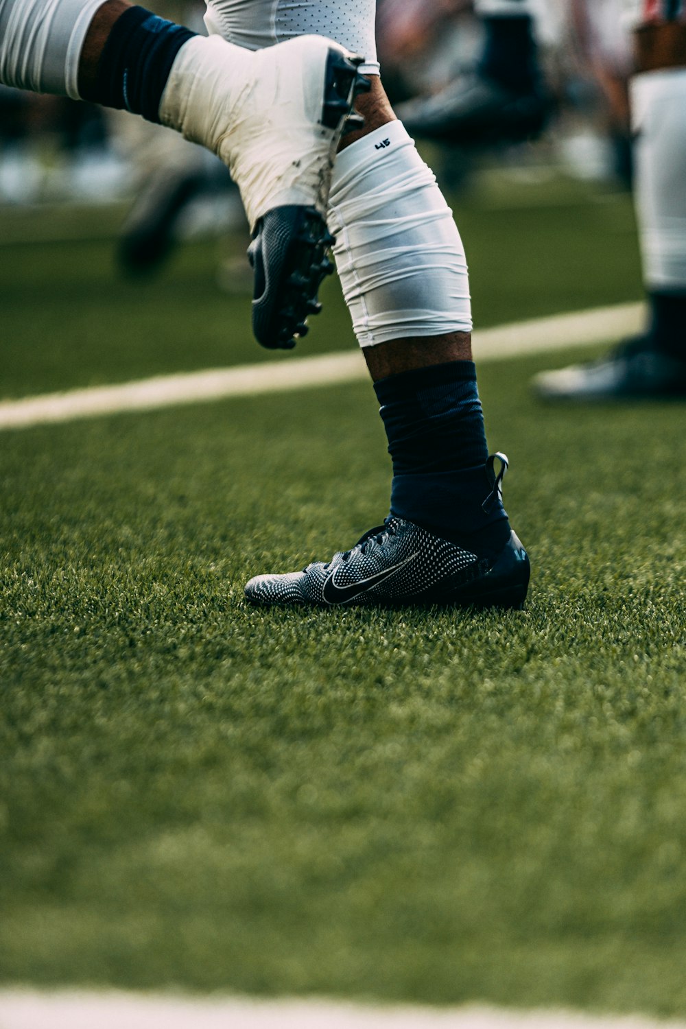 a close up of a football player's feet on the field