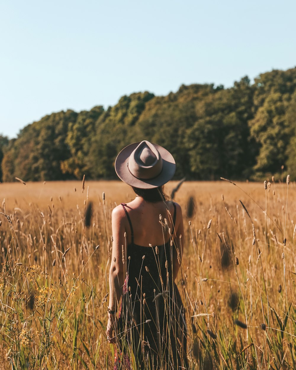 woman wearing black spaghetti strap dress