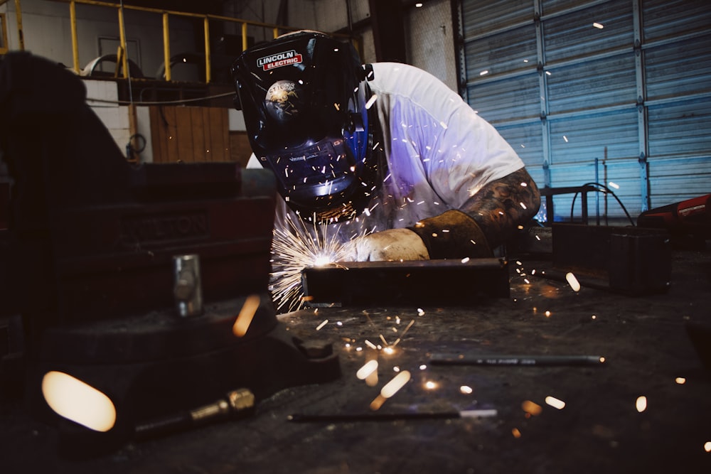 man welding inside room