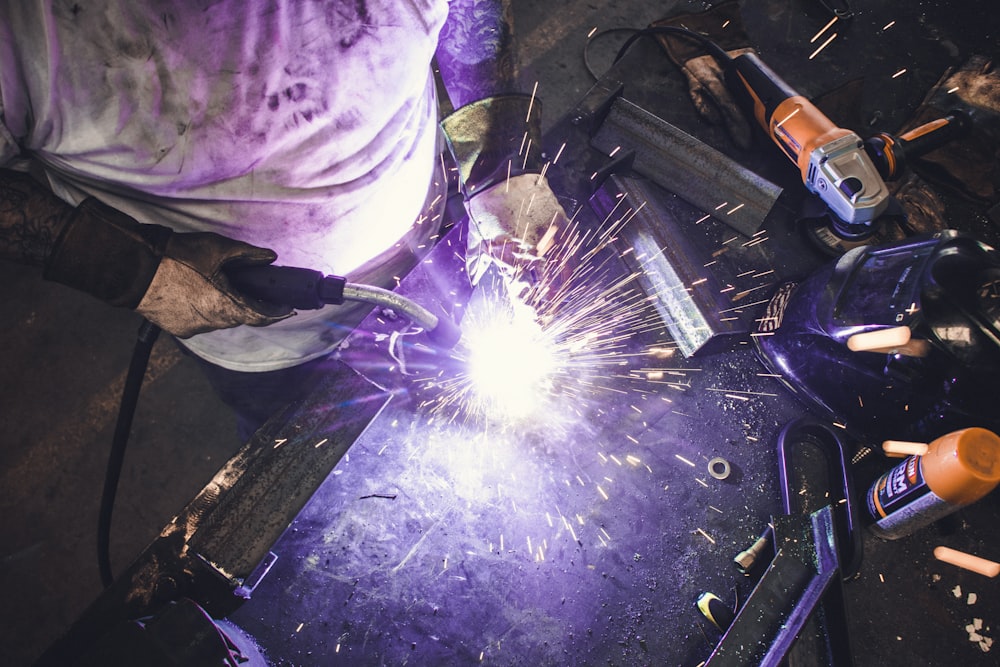 man welding a tool