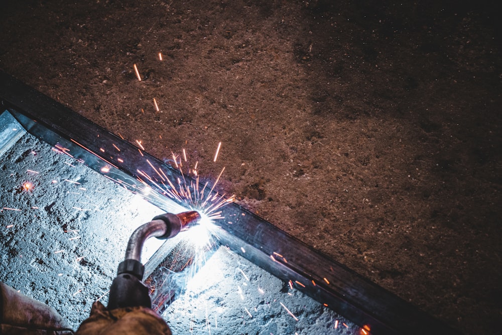 a person using a grinder on a piece of metal