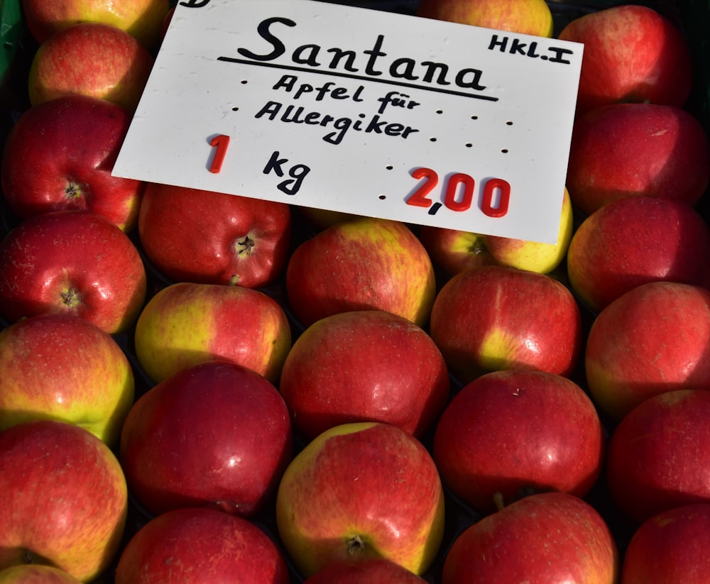 a pile of red and yellow apples for sale