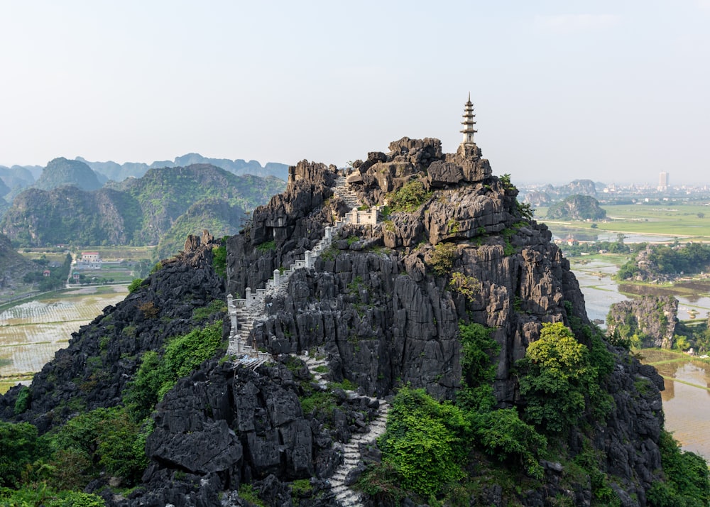 tower on brown cliff during dayti,e