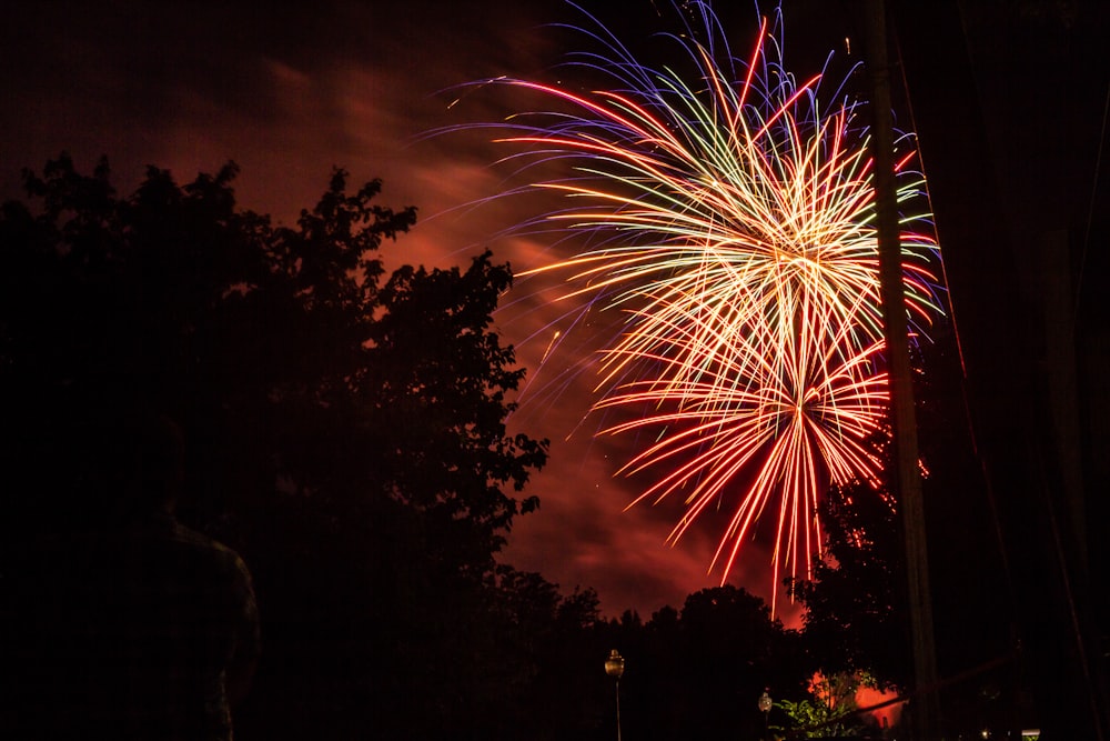 a firework is lit up in the night sky