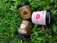 Three ice cream containers labeled 'Good Fettle' are placed on vibrant green grass. The containers include flavors such as Mocha Almond, Creamy Strawberry, and Belgian Chocolate Crunch. Each container features calorie information and playful design elements.