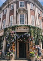The charming exterior of Tattershall Castle Cafe with blooming flowers outside.