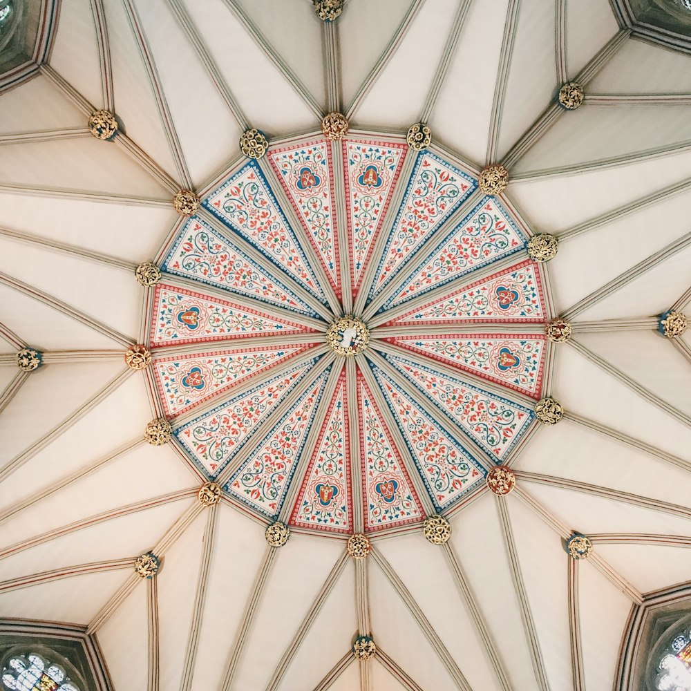a close up of a ceiling with a clock on it