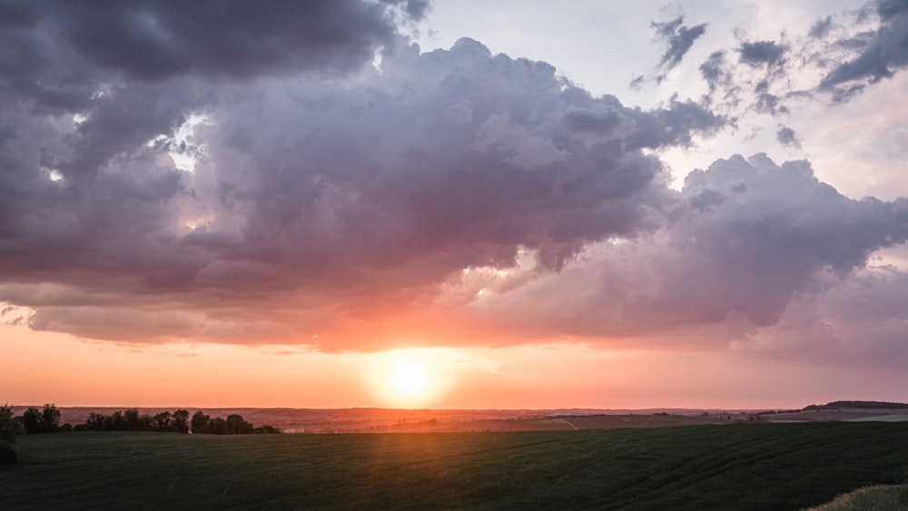 body of water under white skies during sunrise