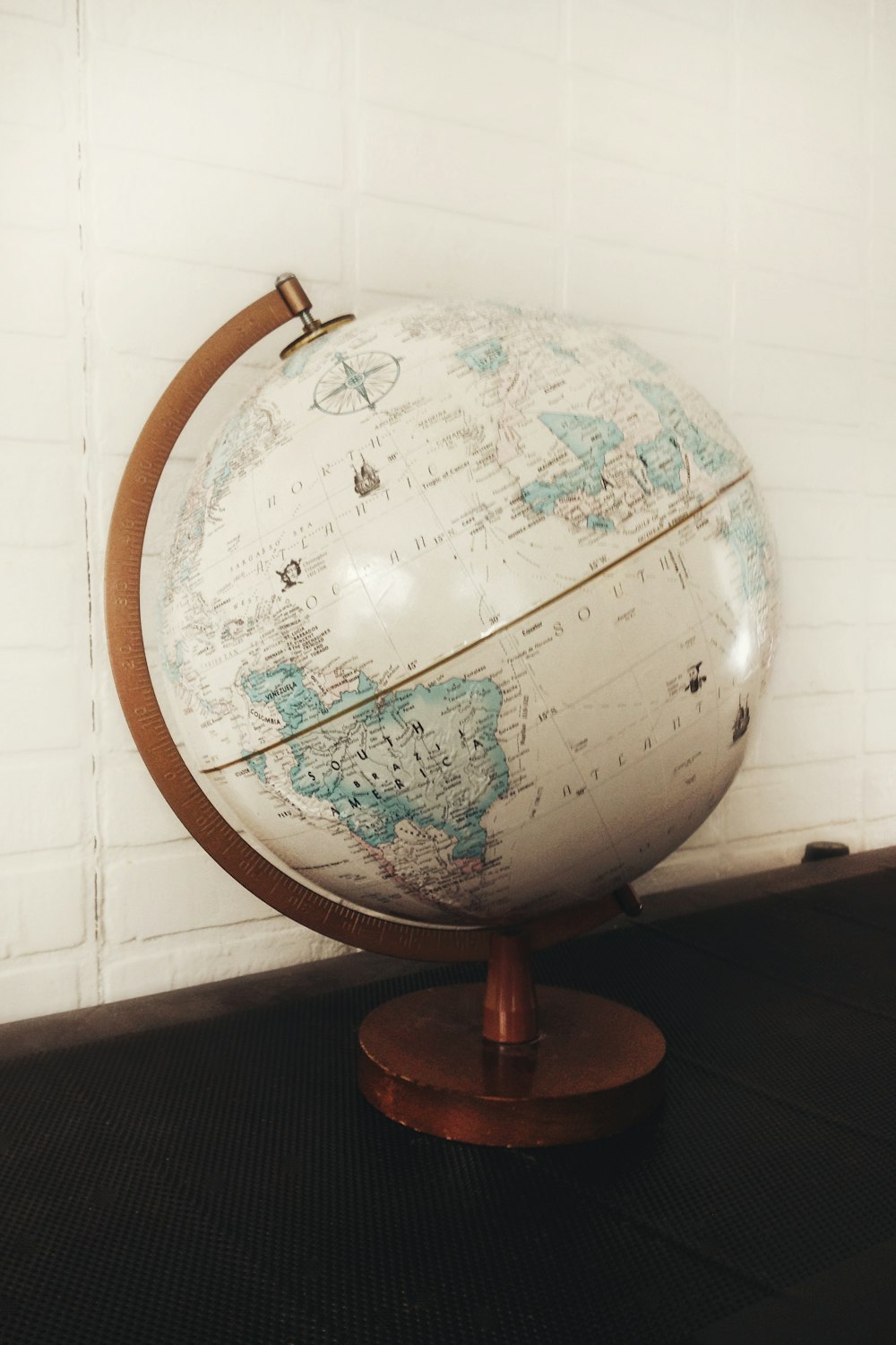 white and brown desk globe