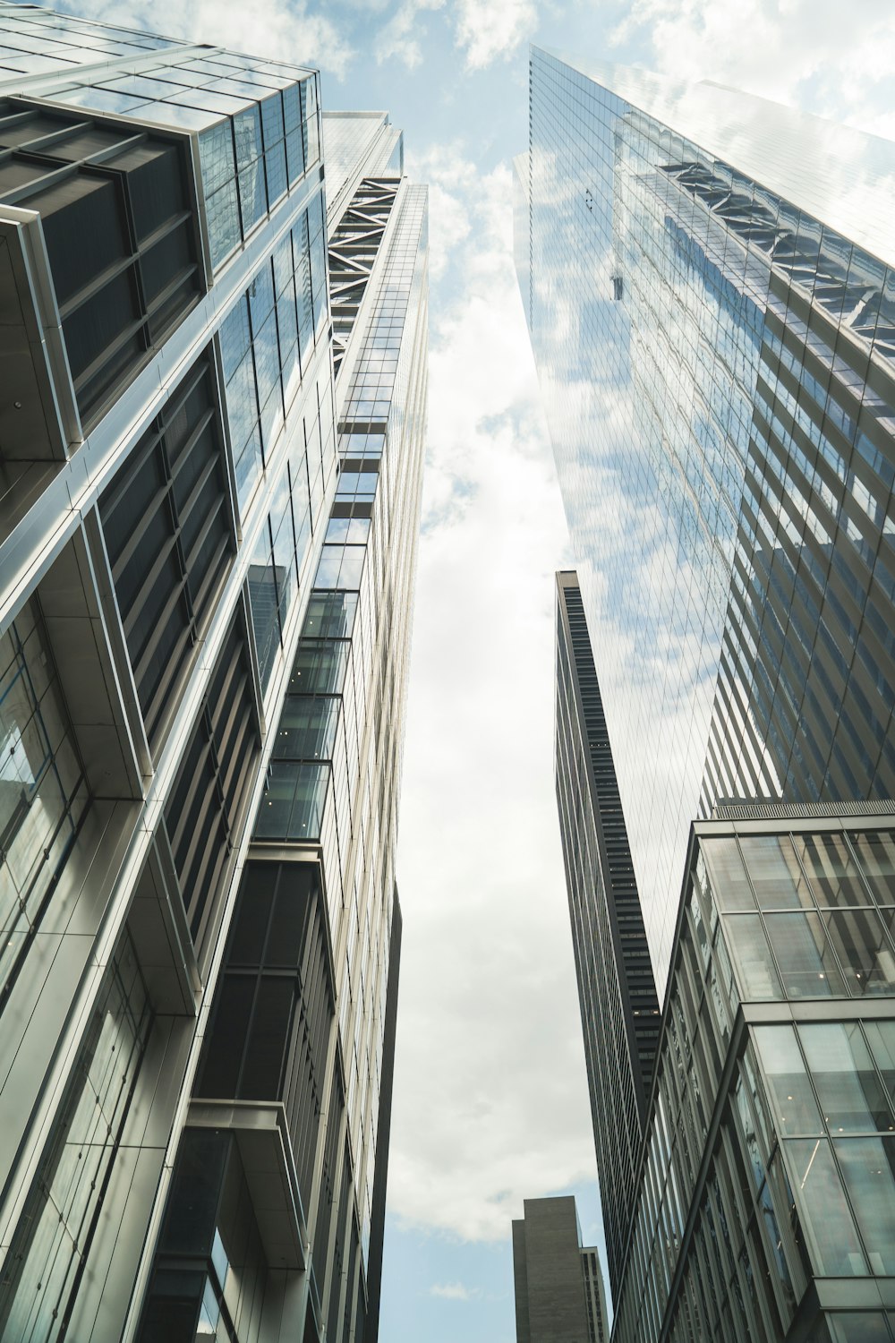 low-angle photography of high-rise glass buildings