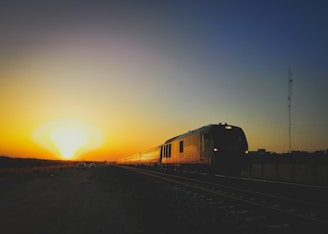 Train equipped with advanced rail safety monitoring technology at sunset.