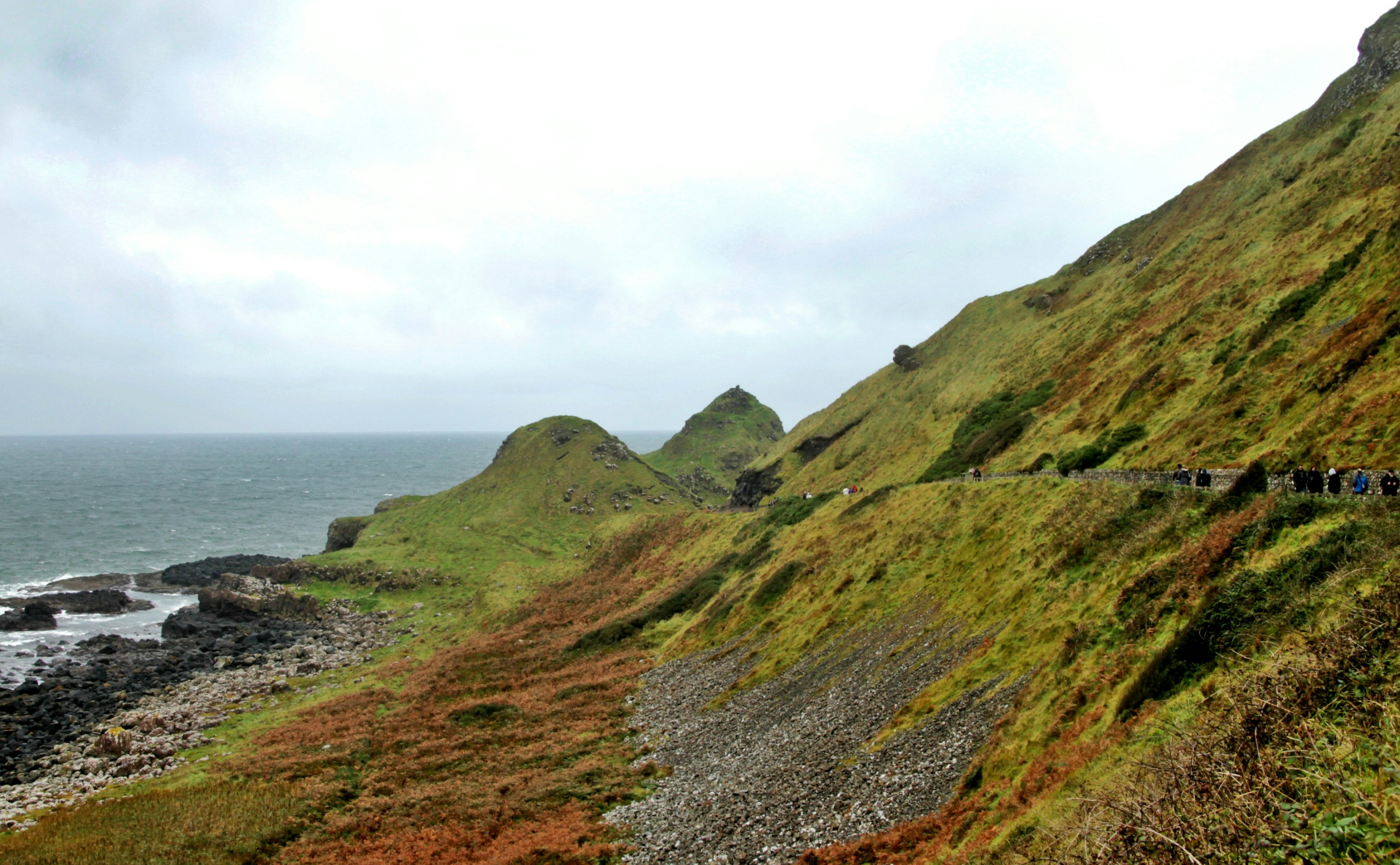 green grass mountain during daytime, coastal walk
