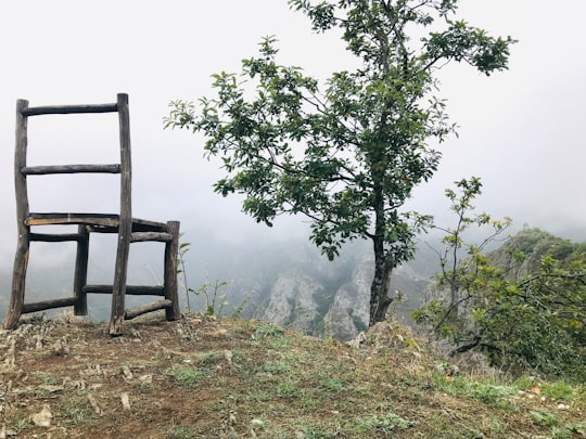 empty gray wooden chair looking at mountain in Halidzor Armenia