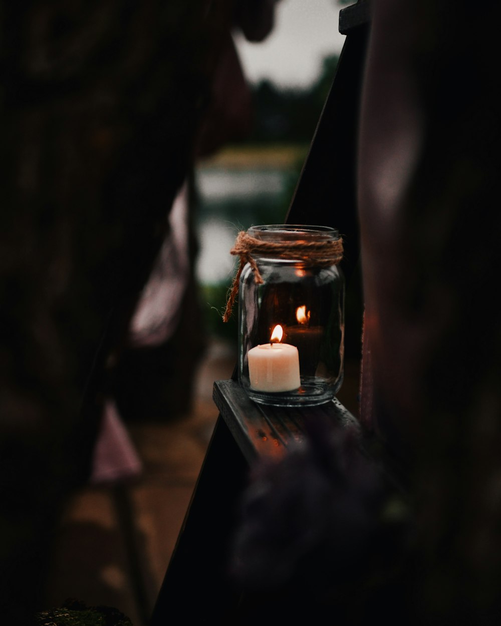 white tealight candle inside clear mason jar