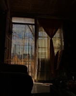 Blackout room divider curtains hanging in a softly lit room creating a private nook.