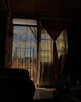 A cozy interior corner decorated with a boho bead curtain framing a window with soft natural light.