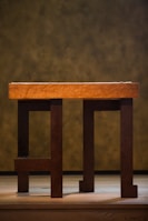 Finished wooden dining table with polished surface and sturdy legs in a home setting.