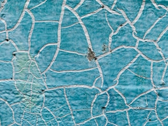 a close up of a blue wall with white lines on it