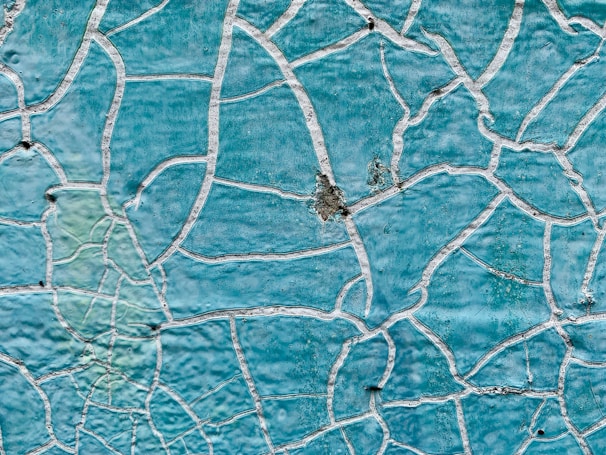 a close up of a blue wall with white lines on it