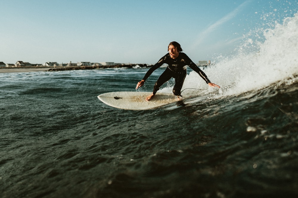 man playing surfboarding during daytime