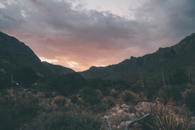 A scenic landscape of the surrounding desert with mountains in the background.