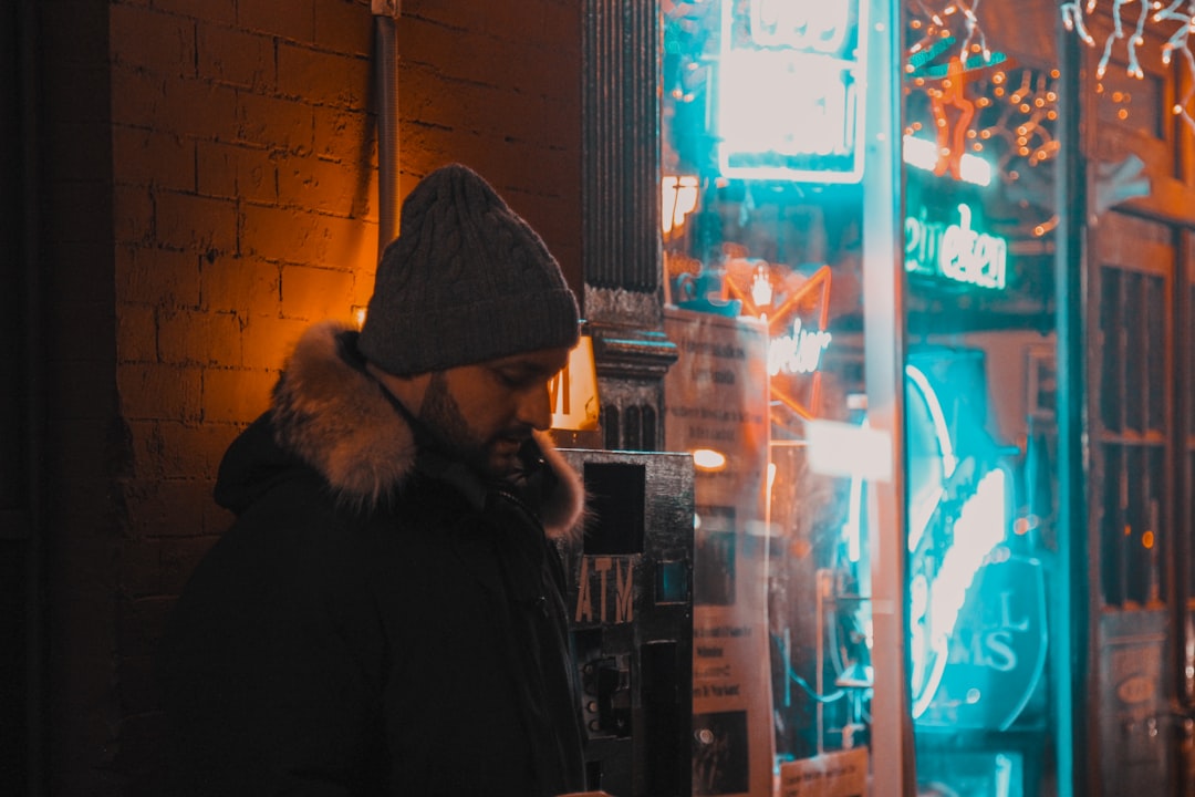 man in black and brown fur-trimmed hooded jacket,