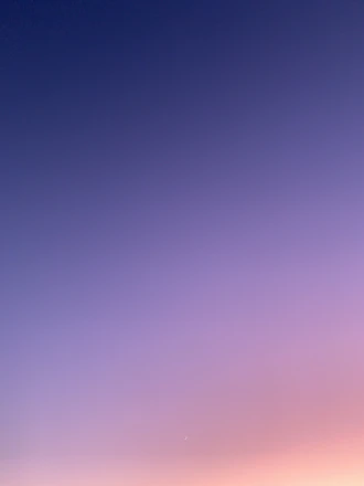 a group of people standing on top of a sandy beach