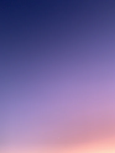 a group of people standing on top of a sandy beach