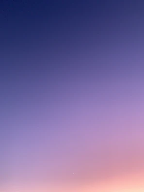a group of people standing on top of a sandy beach