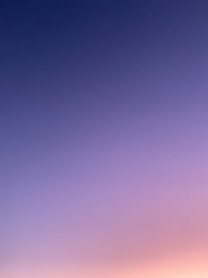 a group of people standing on top of a sandy beach