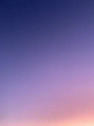 a group of people standing on top of a sandy beach