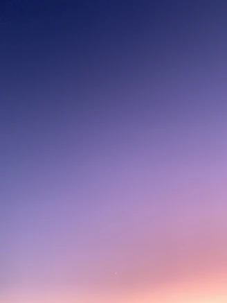 a group of people standing on top of a sandy beach