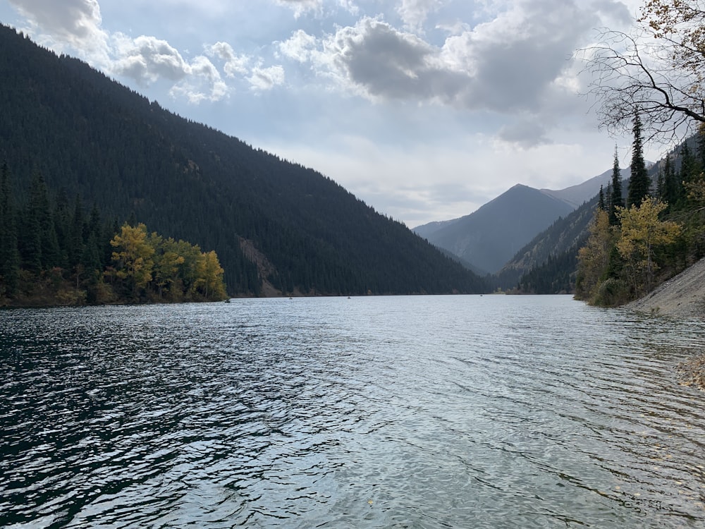 body of water and mountains during day