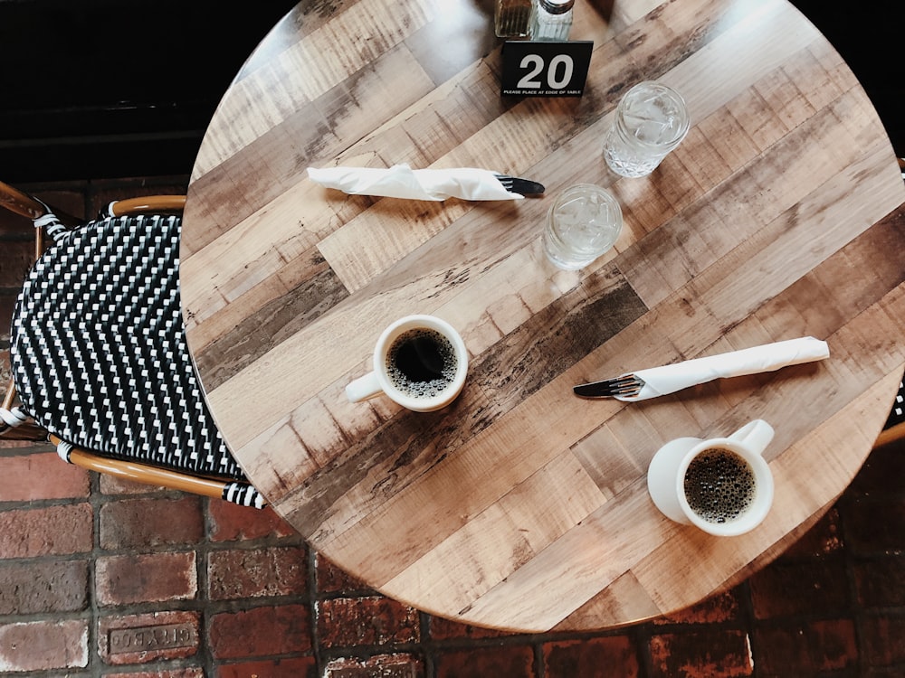 two near full mugs on wooden table