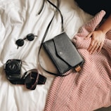 black Canon DSLR camera and black sunglasses