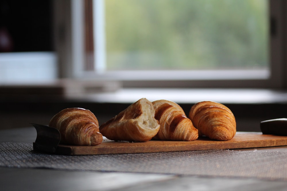 selective focus photography of four brown croissant breads