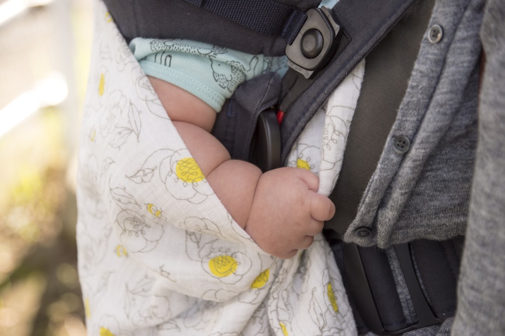 selective focus photography of baby's hand