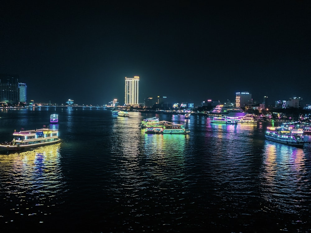 lighted boats on body of water during nighttime