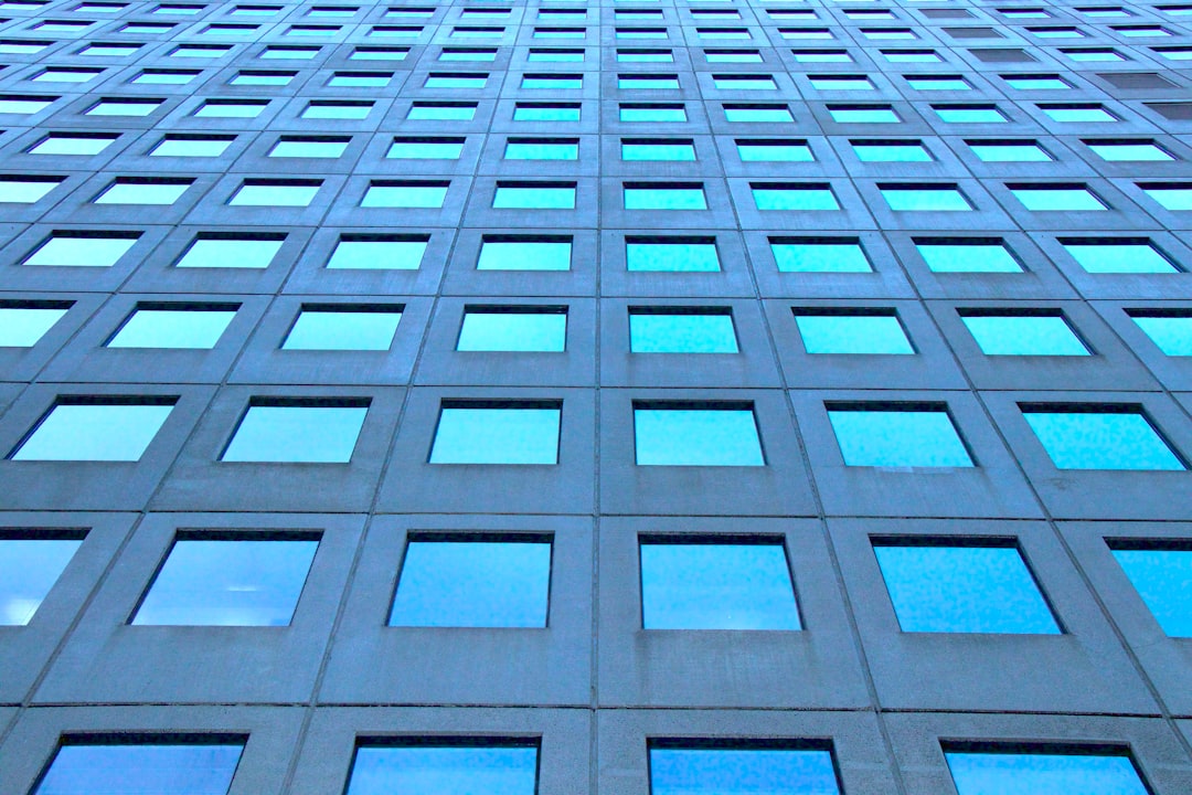 low-angle photography of blue highrise glass building