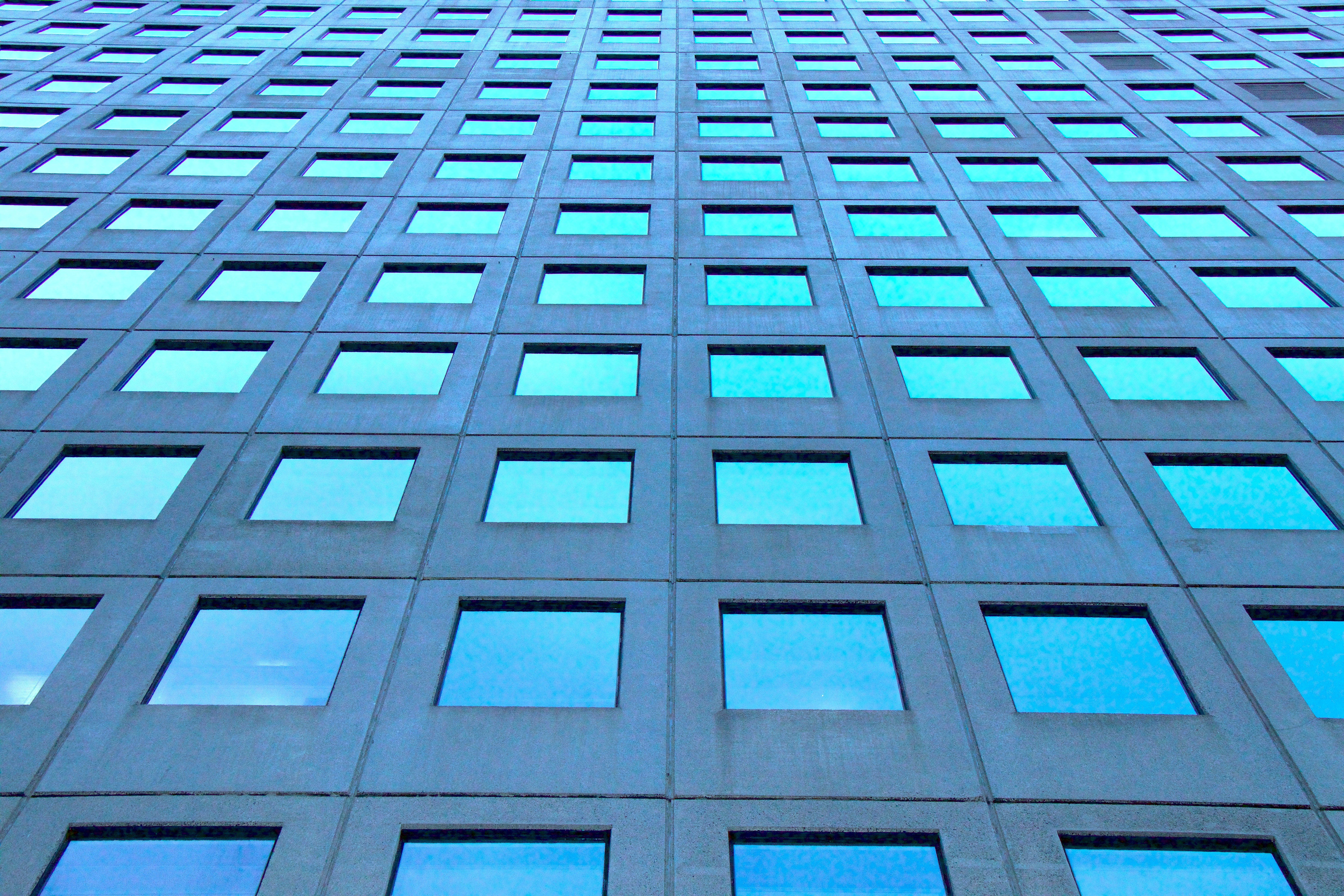 low-angle photography of blue highrise glass building