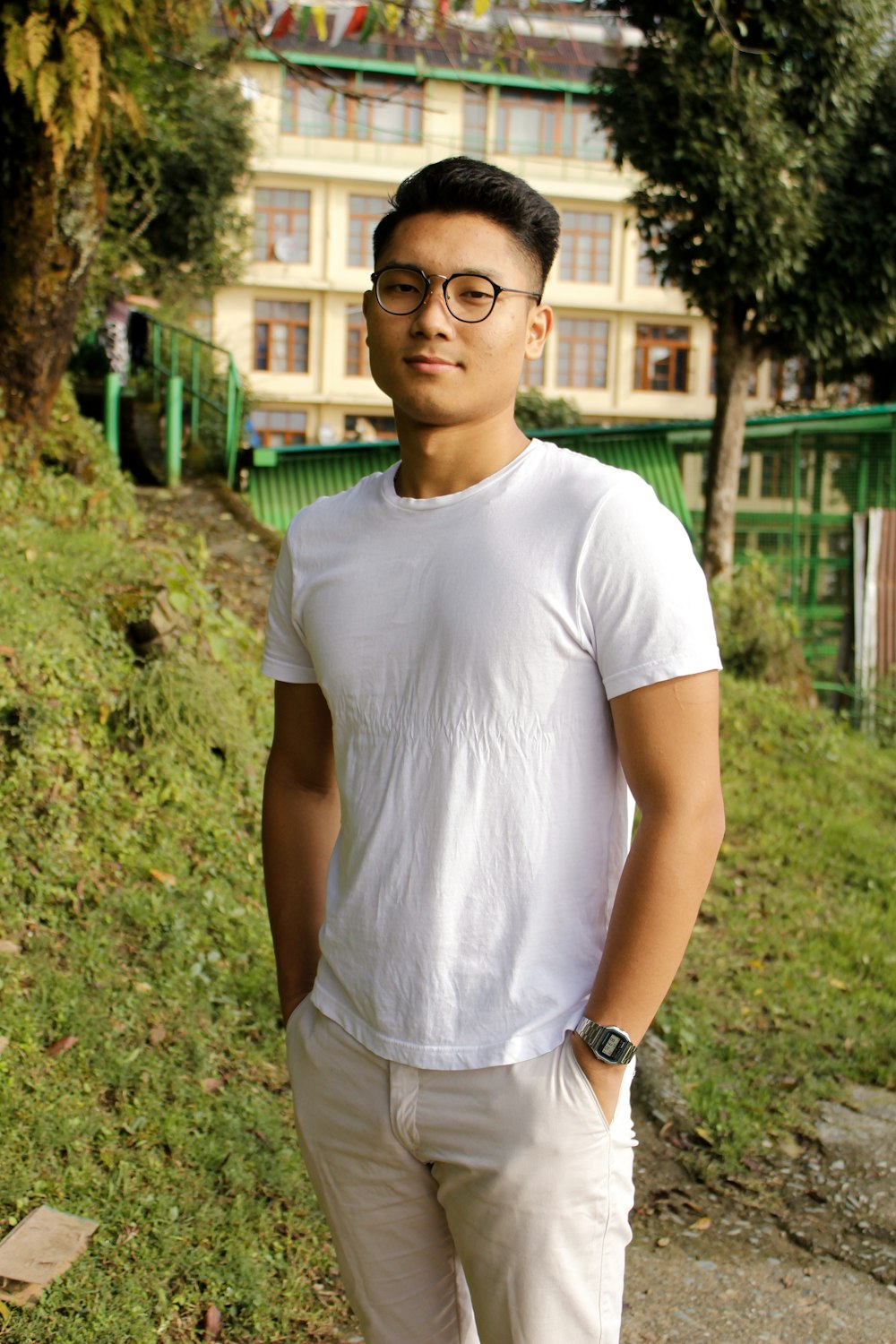 man smirking and standing near trees