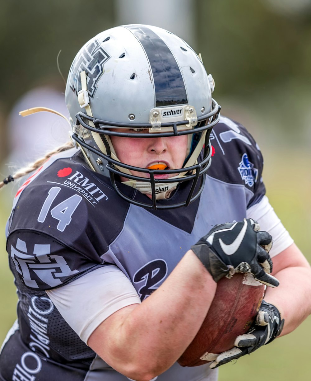 man standing and holding football