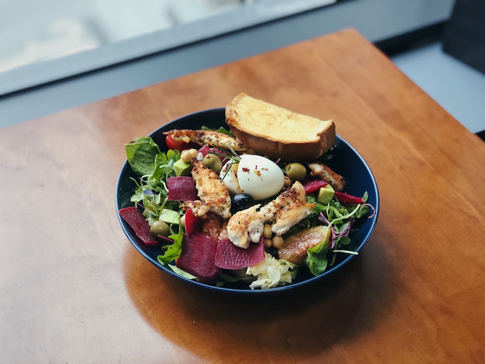 vegetable salad on blue bowl