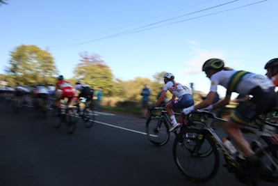 A group of cyclists racing down a winding road during a championship.