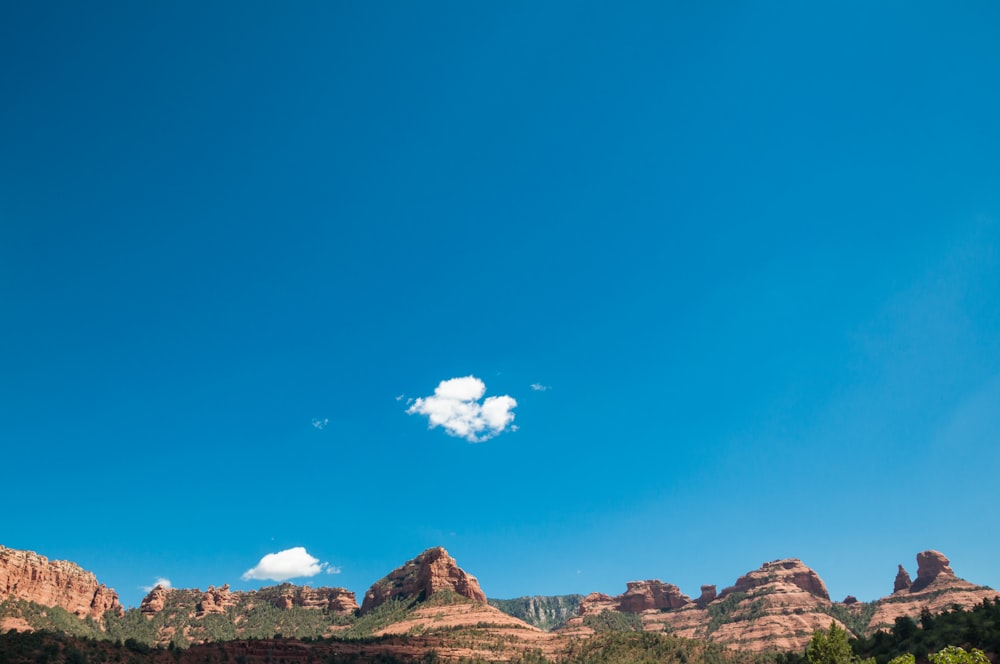 brown and black mountains under blue sky at daytime